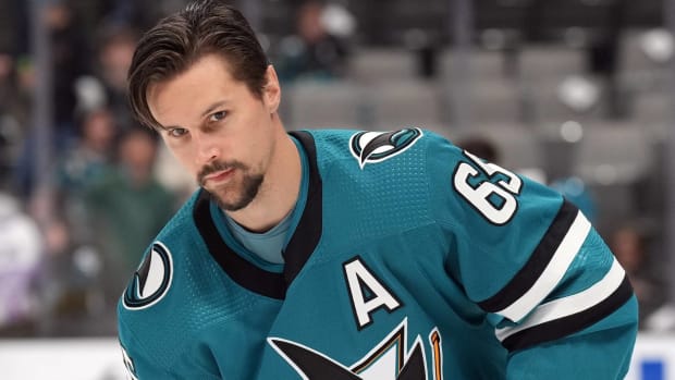 Sharks defenseman Erik Karlsson warms up without a helmet before a game.